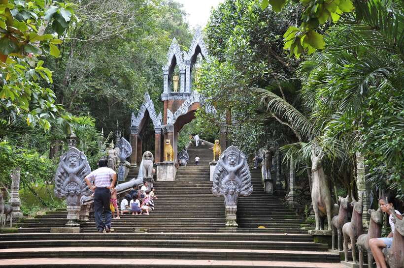 From Siem Reap: Small-Group Phnom Kulen Waterfall Day Tour - The Grand Reclining Buddha statue, carved right into the experience